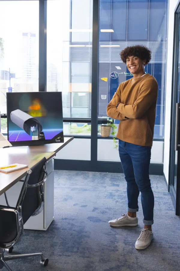smiling-young-man-standing-confidently-in-modern-o-2025-04-03-11-52-37-utc